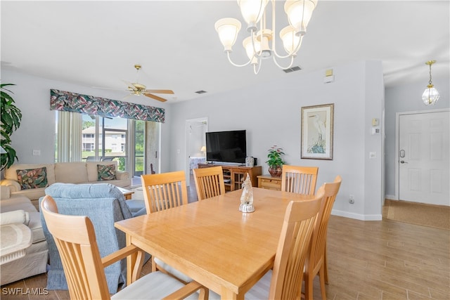 dining room with light wood-type flooring and ceiling fan with notable chandelier