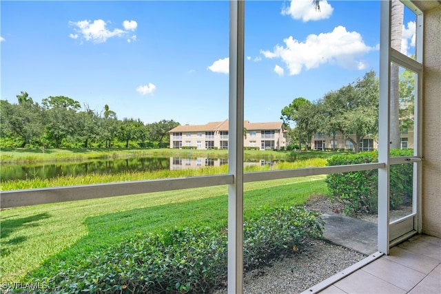 unfurnished sunroom featuring a water view