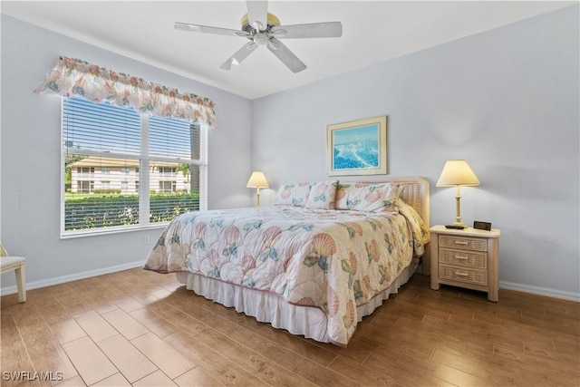 bedroom with ceiling fan and hardwood / wood-style flooring