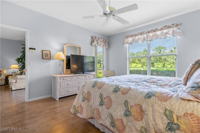 bedroom with ceiling fan and wood-type flooring