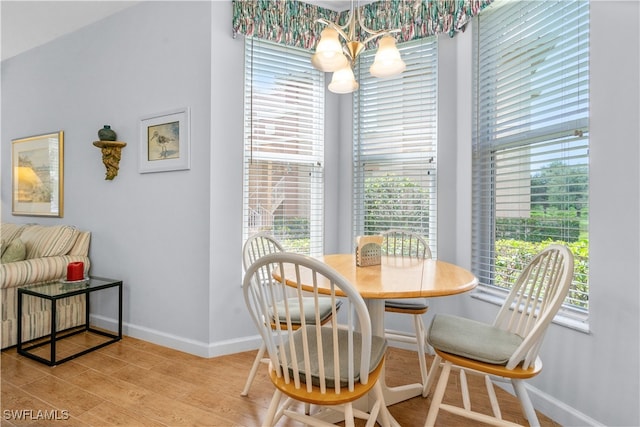 dining room featuring an inviting chandelier and light hardwood / wood-style flooring