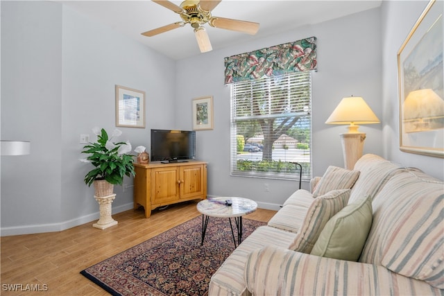 living room with light hardwood / wood-style floors and ceiling fan