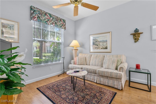 living room featuring light wood-type flooring and ceiling fan