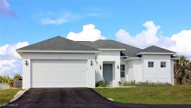 view of front of property with a front lawn, central AC, and a garage