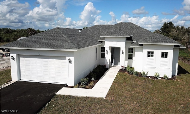 view of front facade featuring a front yard and a garage