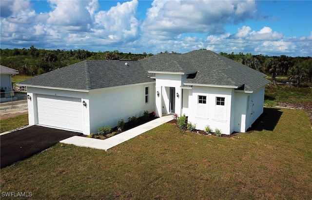 view of front of house with a garage and a front lawn