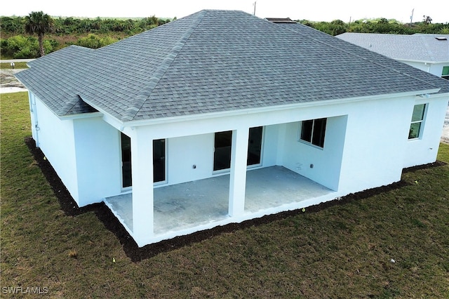 back of house with a patio and a yard