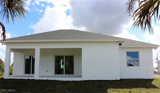 rear view of house with a yard