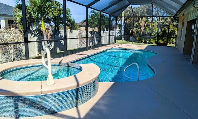 view of swimming pool with an in ground hot tub, a lanai, and a patio