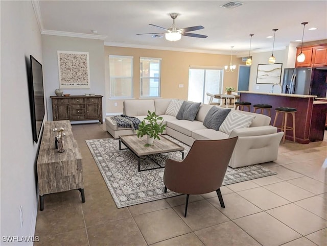 living room with ornamental molding, light tile patterned floors, and ceiling fan