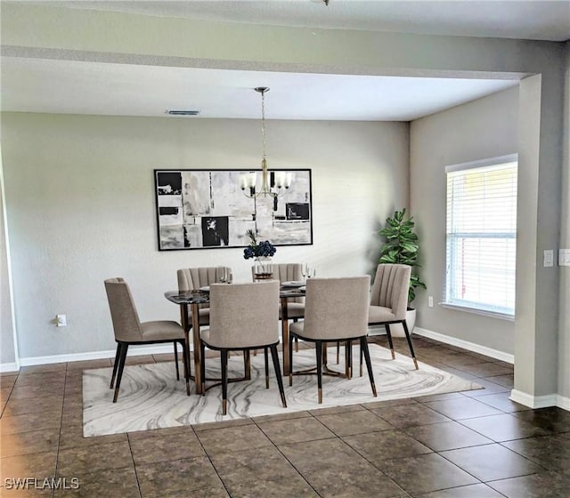 tiled dining space featuring a notable chandelier