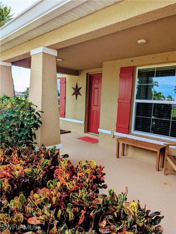 entrance to property featuring stucco siding