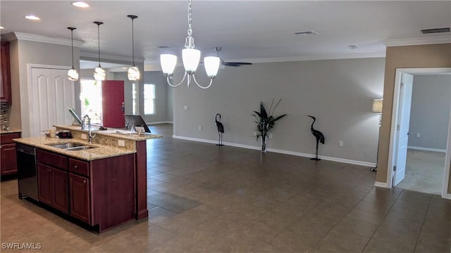 kitchen with crown molding, hanging light fixtures, sink, and a center island with sink