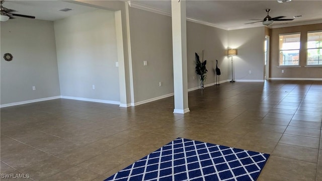 unfurnished room featuring ceiling fan, ornamental molding, and dark tile patterned flooring