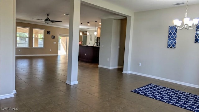 tiled empty room with crown molding and ceiling fan with notable chandelier