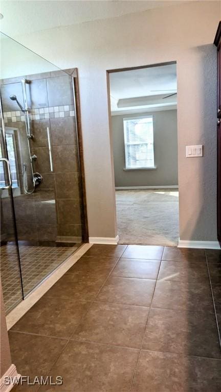 bathroom featuring tile patterned floors and a shower with shower door