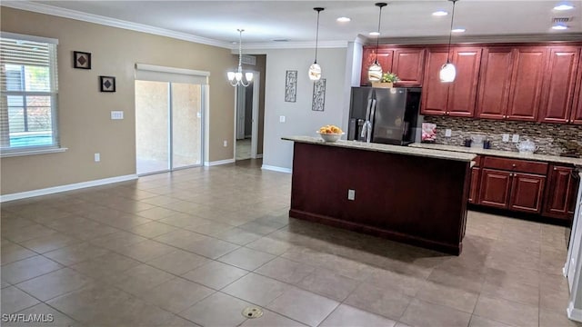 kitchen featuring stainless steel refrigerator with ice dispenser, tasteful backsplash, crown molding, decorative light fixtures, and a kitchen island