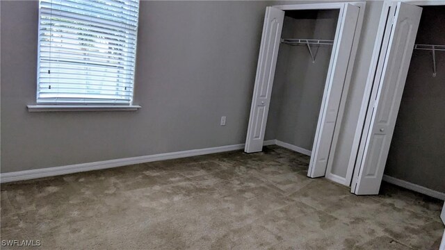 unfurnished bedroom featuring carpet and baseboards