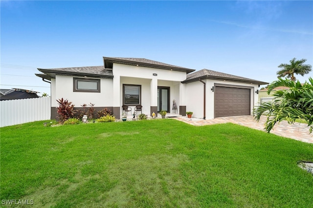 view of front of house featuring a front yard and a garage