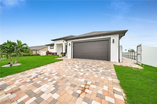 view of front of property featuring a front lawn and a garage