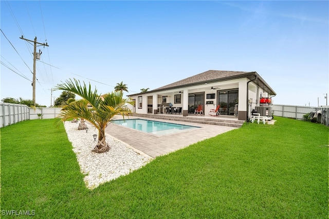 view of pool featuring a patio, a yard, and central AC unit