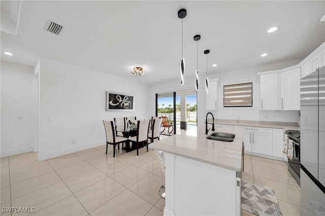 kitchen featuring white cabinets, hanging light fixtures, sink, stainless steel electric stove, and light stone countertops