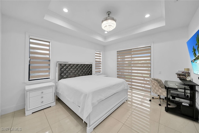 bedroom featuring a tray ceiling, light tile patterned floors, and a chandelier