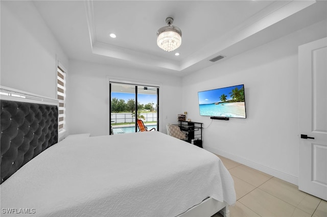 bedroom featuring a notable chandelier, a tray ceiling, access to outside, and light tile patterned flooring