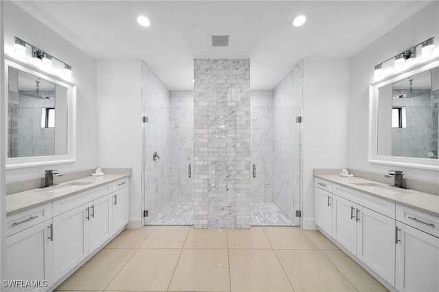 bathroom featuring walk in shower, vanity, and tile patterned floors