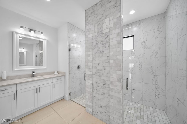 bathroom featuring vanity, tile patterned flooring, and an enclosed shower