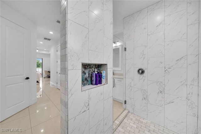 bathroom featuring a tile shower and tile patterned flooring