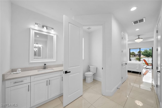 bathroom featuring vanity and toilet