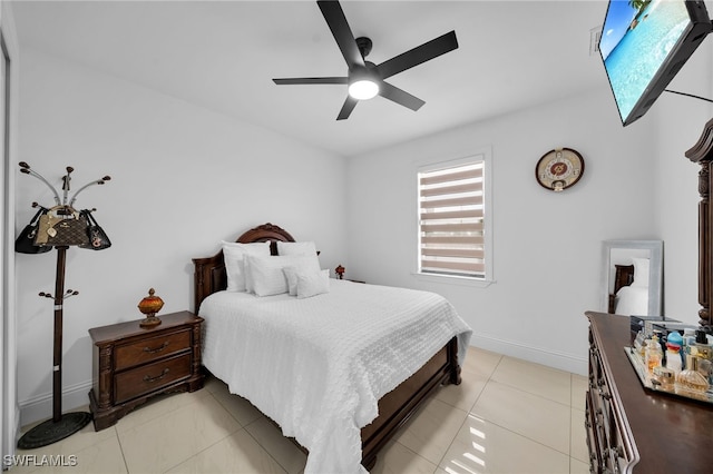 tiled bedroom featuring ceiling fan