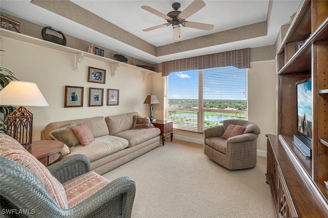 carpeted living room featuring ceiling fan