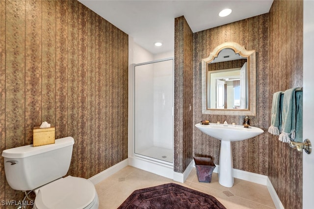 bathroom featuring a shower with door, tile patterned floors, and toilet