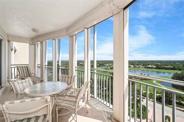 sunroom / solarium with a water view