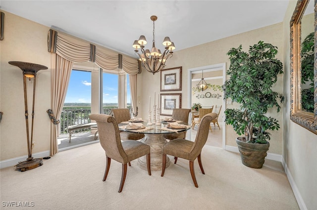 carpeted dining area with a notable chandelier