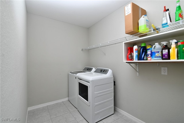 clothes washing area with separate washer and dryer and light tile patterned floors