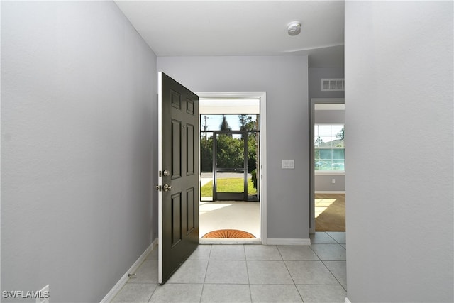 foyer entrance with light tile patterned floors