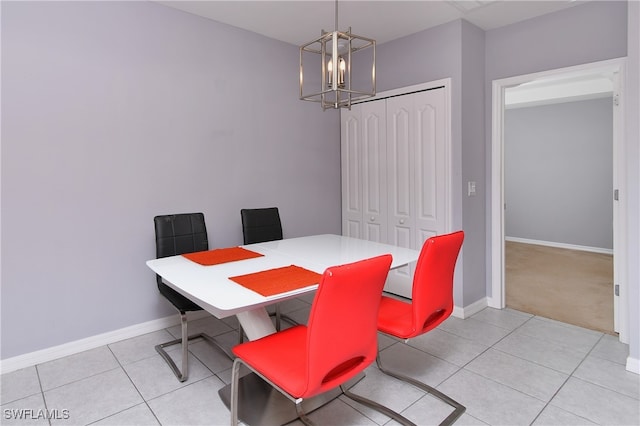 dining room with a notable chandelier and light tile patterned floors