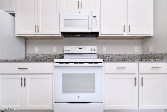 kitchen featuring light stone countertops, white cabinets, and white appliances