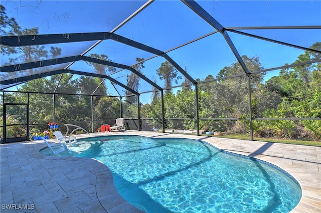 view of pool with a lanai and a patio area