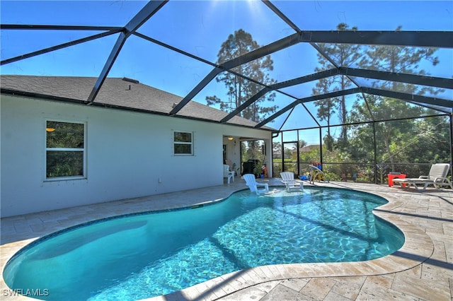 view of pool with a lanai, a patio, and pool water feature