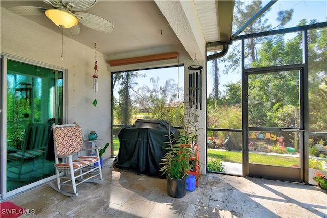 sunroom featuring ceiling fan