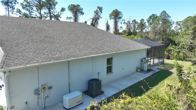 view of home's exterior with cooling unit and a yard