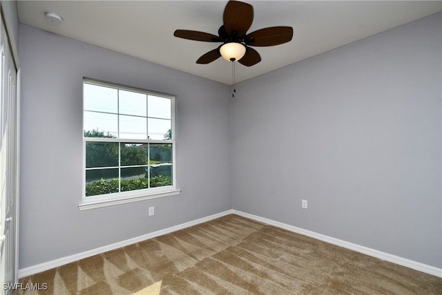 carpeted empty room featuring ceiling fan and a healthy amount of sunlight