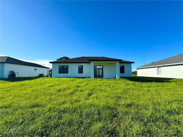 back of house with a yard