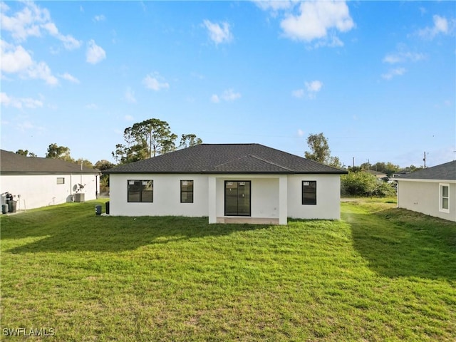 rear view of property with a yard