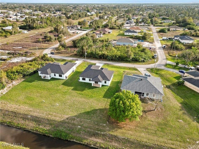 bird's eye view featuring a water view and a residential view