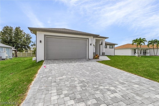 view of front of home with a garage and a front lawn